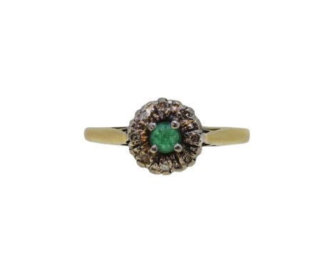 An emerald and diamond cluster ring, head diameter 8.1mm, size I, stamped '18CT PLAT', weight 2.1g