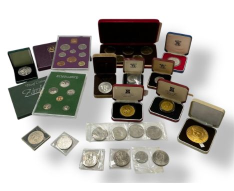 A collection of British, Isle of Man and Zimbabwe coins, including a cased proof set of pre-1971 British currency; a proof se
