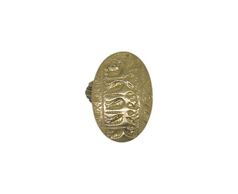 A decorative panel ring, oval shaped carved panel, approximately 28 x 20mm, size L½, stamped '750', weight 12.1g