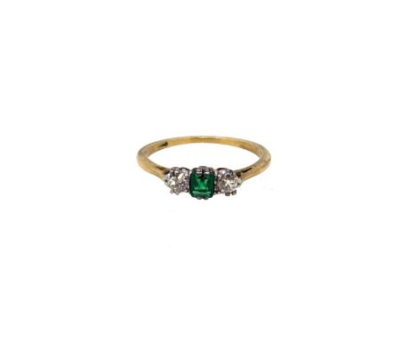 An emerald and diamond three stone ring, size K½, tested as 18ct gold, weight 1.8g