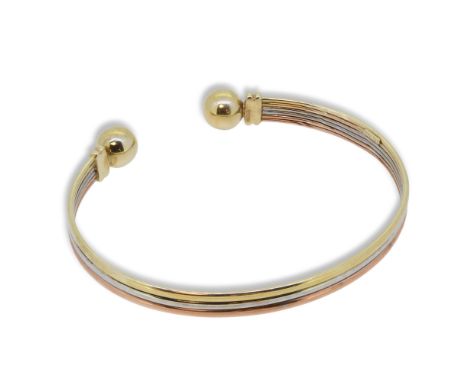 A 9ct three colour gold torc bangle, inside diameter 6.1cm, width 5.6mm, hallmarked 9ct gold, weight 6g