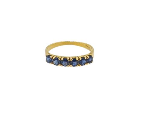 A sapphire half hoop style ring, six claw set sapphires, width 3.4mm, size K½, unhallmarked, stamped '585', weight 1.8g