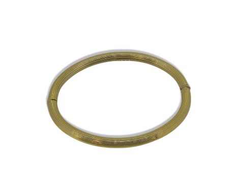 A hinged bangle, inside diameter 6.2cm, stamped '750', weight 11.7g