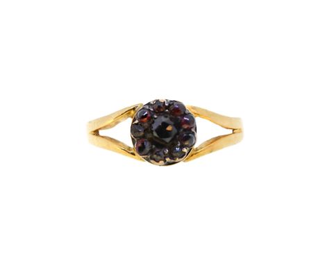 A garnet cluster ring, head diameter 8.2mm, size R½, unhallmarked, stamped 18ct, weight 2.3g