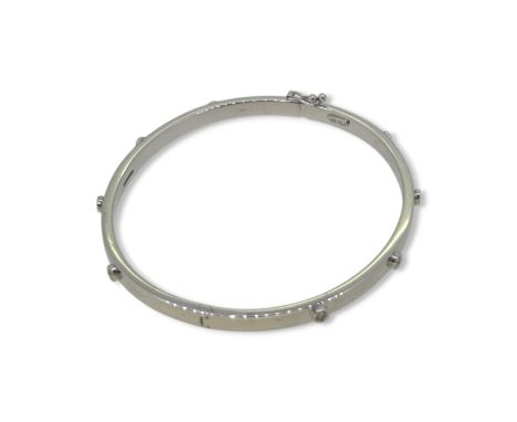 A 9ct gold diamond set bangle, inside diameter 6cm, width 4mm, hallmarked 9ct gold, weight 6.4g