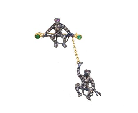 A diamond, emerald and ruby monkey brooch/pendant, monkeys set with rose cut diamonds and cabochon rubies for eyes, with one 