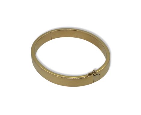 An 18ct gold bangle, inside diameter 5.9cm, width 8mm, hallmarked 18ct gold, weight 18.1g