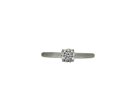 An 18ct gold diamond set ring, illusion set round brilliant cut diamond, estimated approximate weight 0.10ct, surrounded by n