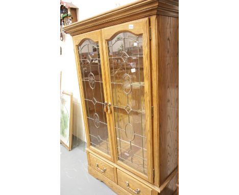 Modern light oak display cabinet with lead glazed doors. 110 x 42 x 176 cm H. This lot is not available for in-house P&amp;P 