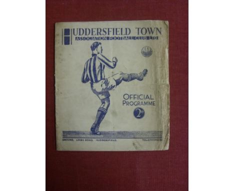 1937/38 Huddersfield v York City, a programme from the FA Cup tie played on 09/03/1938, creased & frayed edges, torn