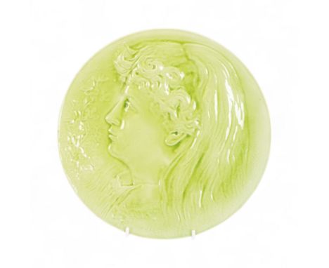 Burmantoft faience plaque depicting a young woman in profile, in green glaze, with impressed marks beneath Burmantofts Faieng