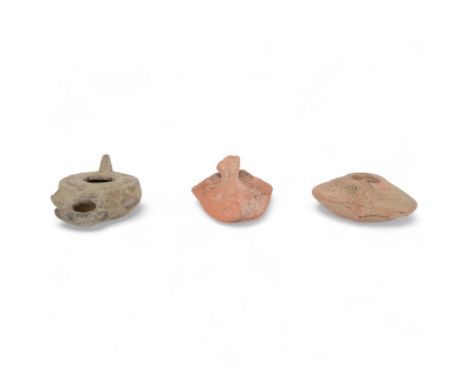 Antiquities; Crusader period terracotta oil lamp, highly decorative, with two other oil lamps 