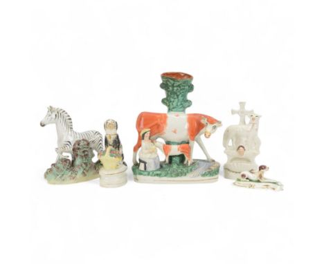 Five 19th century and later Staffordshire figures, comprising cow and calf slip vase, recumbent dog, zebra, sheep and seated 
