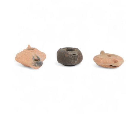 Antiquities; Greco-Roman dark glazed zoomorphic oil lamp, together with two Hellenistic terracotta oil lamps