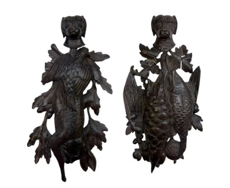 Two 19th century oak carvings, each depicting game and fish with hunting dog mask above, H31cm
