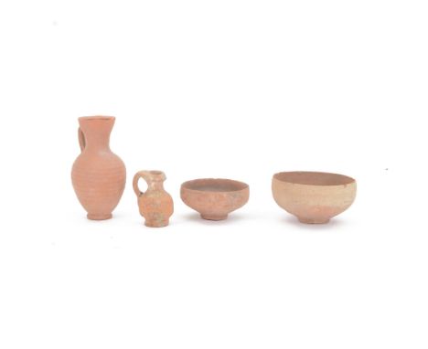 Antiquities; Nabataean red terracotta egg-shell bowl, together with another smaller example and two terracotta jars 