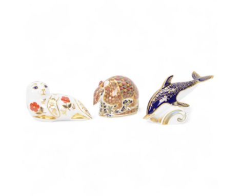 Royal Crown Derby paperweights, comprising Seal with gold stopper, Dolphin with silver stopper and Armadillo with silver stop