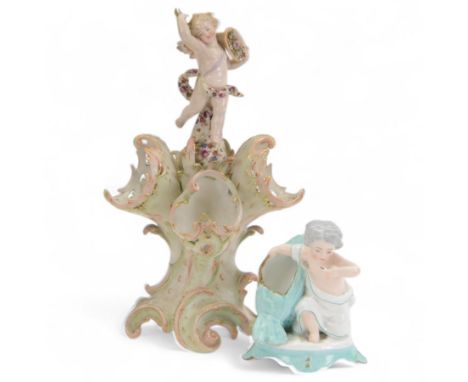 Sitzendorf centre piece, topped with a cherub above three shells upon scrolling feet, together with another continental figur