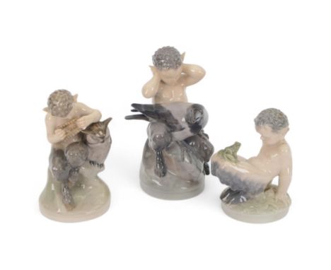 Three Royal Copenhagen figures, comprising Faun and Frog no. 1713,  Fawn and Owl no. 2107 and Faun with a Raven no.2113