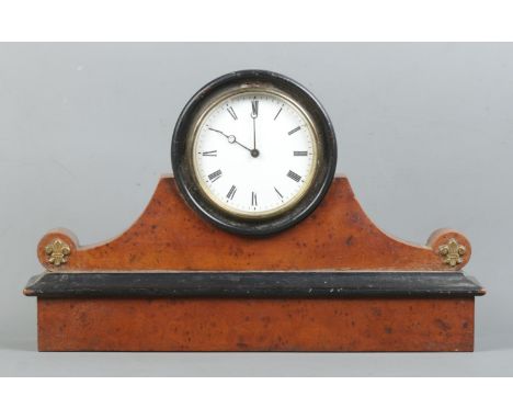 A walnut and ebonised drum mantle clock, with brass Fleur de Lys to the rounded shoulders. Featuring Roman Numeral dial and m