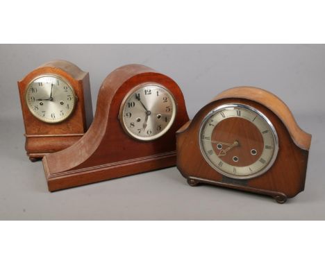 An Alexander Clock Co mantel clock together with a Hamburg American Clock Company HAC mantel clock and a napoleon style mante