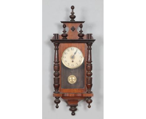 A mahogany wall clock with enamel face, turned columns and finials.Hx71cm  