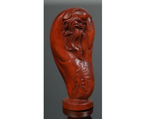 A hand carved hardwood netsuke of the god of longevity, signed.  