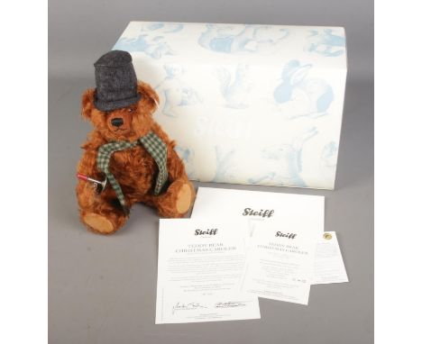 A boxed limited edition Steiff mohair teddy bear titled Teddy Bear Christmas Caroler with top hat and chamber stick. 036071, 