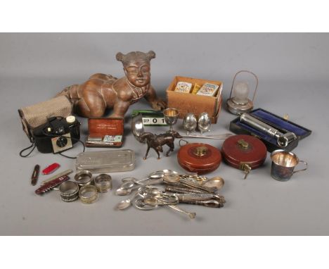 A box of assorted collectables to include carved figure of a baby, silver plate, John Rabone tape measure featuring WWII broa