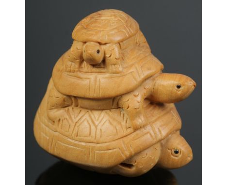 A hand carved hardwood netsuke of a trio of turtles.  