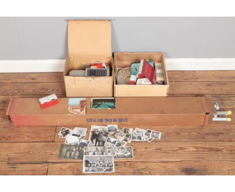 A quantity of projection equipment and photographs. Includes boxed semi automatic projector, monochrome photographs, projecti