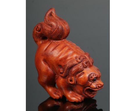 A hand carved hardwood netsuke of Foo Dog/Baby Dragon. Signed.  