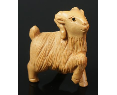 A hand carved hardwood netsuke of a goat.  