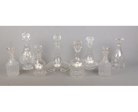 Eight glass decanters, including one Waterford example, together with five ceramic Coalport decanter labels; Gin, Whisky, She