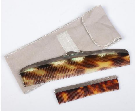 A Georg Jensen silver and tortoise shell effect comb in sleeve, along with a similar smaller silver comb.  