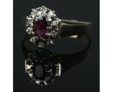 A 9ct gold ruby and diamond ring. Size R 1/2. 3.2g.  