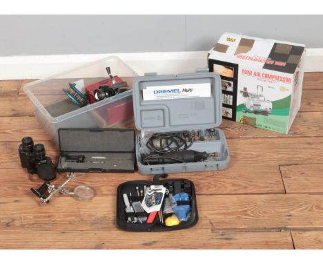 A boxed mini air compressor model AS18-2 along with cased Dremel Multi tool and collection of precision tools.  