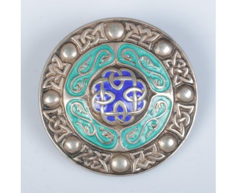 After Alexander Ritchie silver and enamel brooch formed as a Celtic shield. Hallmarked Birmingham 1946 by A H Darby and Son. 