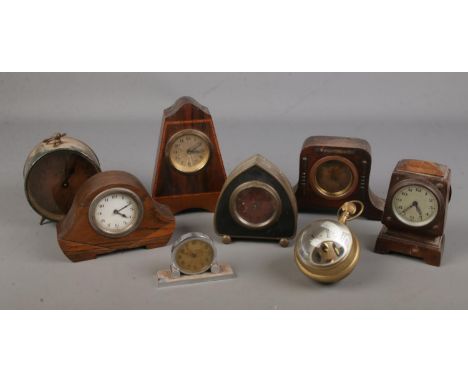 A large collection of small clocks including several mantel clocks, bullseye clock, services competitor clock etc  