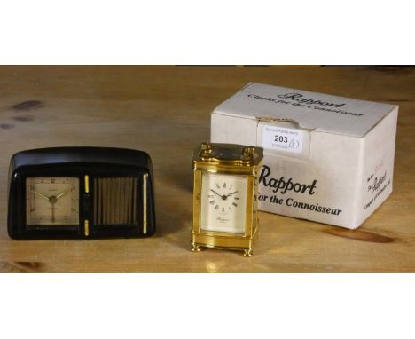 A Rapport serpentine small brass carriage clock, mvt no. 1900, ref 8563, 8.5 cm, box, and a Goldbruhl musical alarm clock in 