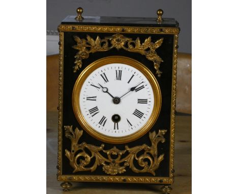 A 19th century French ebonised and gilt metal mounted mantle clock, pendulum, 21 cm 