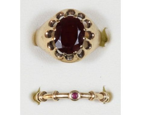 A 14k gold ruby set ring, size L, 1.9 gms and a 9ct gold garnet ring, size K, 3.5 gms 