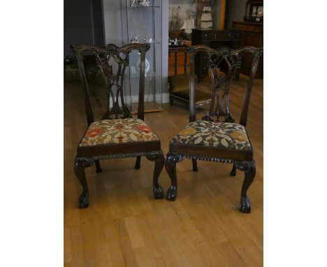 A set of four quality Chippendale-style dining chairs with tapestry seats on claw &amp; ball feet (4) 