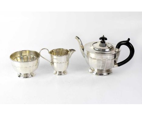 A George V hallmarked silver three-piece tea service, comprising teapot with ebonised handle and finial, matching sugar bowl 