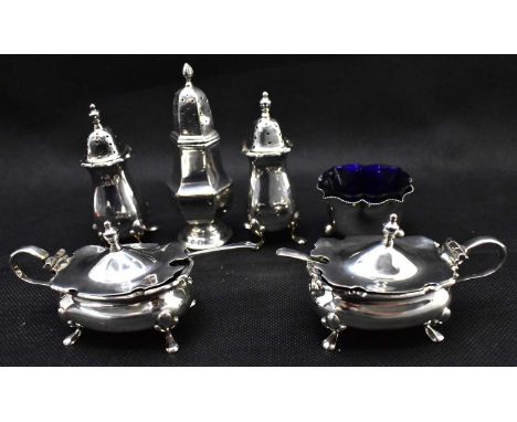 A hallmarked silver matched four-piece cruet set comprising two silver salts with blue liners and two pepperettes, Walker &am