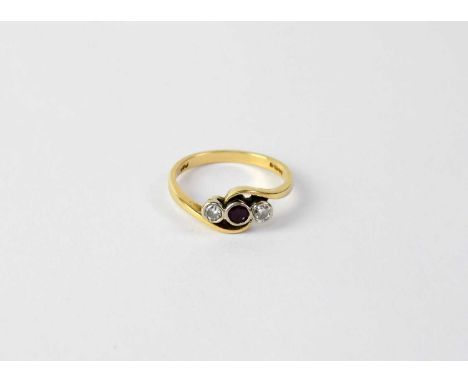 An 18ct yellow gold ring with central collet set ruby with two collet set diamonds on a twist, size M, approx. 3.4g.