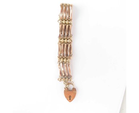 A 19th century 9ct rose gold four bar gate bracelet with heart-shaped gold padlock clasp, length 18.5cm, approx. 20g.