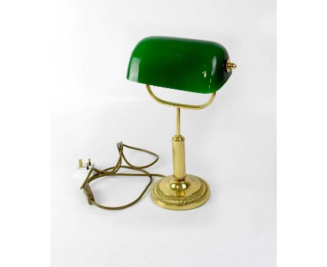 A reproduction brass-effect library lamp with adjustable green glass shade.