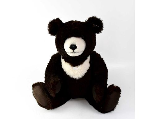 STEIFF; a large plush bear, dark brown with white muzzle and chest, dark brown felt pads, gold button and white tag to ear, h