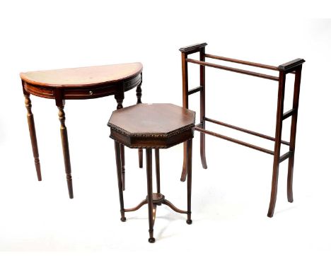 An Edwardian inlaid towel rail, a hexagonal occasional table united by an under tier, and a reproduction demi-lune leather in
